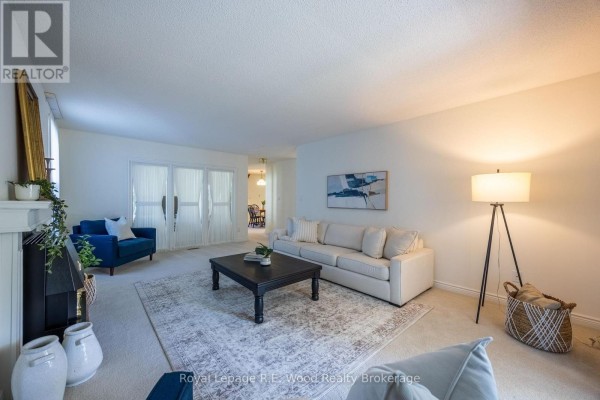 Cream sofa, fireplace, accent chair, and coffee table in living room - 7 Seres Drive Tillsonburg