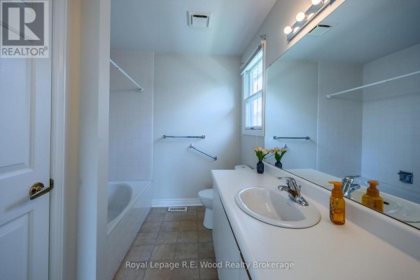 Bathroom with tub, shower, toilet, sink, vanity, mirror and window - 7 Seres Drive Tillsonburg