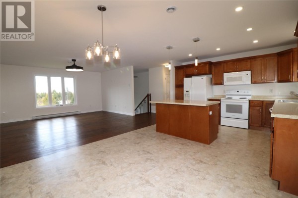 Bedroom with dark hardwood floors, white walls, and a window with a view of trees. - 7 Squires Road, Paradise