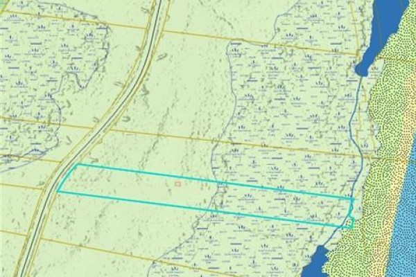 Property map showing a rectangular plot outlined in turquoise, adjacent to water and wetlands. - 7.1 Acres Chemin De La Cedrière, Riviere Du Portage