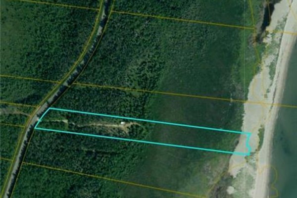 Aerial satellite view showing the property boundary marked by turquoise lines, nestled between woodland and shoreline. - 7.1 Acres Chemin De La Cedrière, Riviere Du Portage