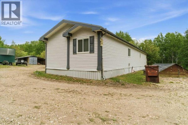 Bedroom with white paneled walls, grey carpet, and a small window. - 70, 25039 Township Road 722, Rural Grande Prairie No  1, County Of