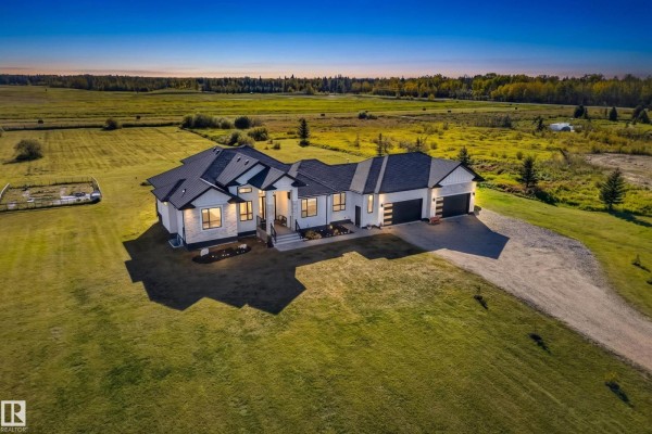 Elevated view of a sprawling modern house with a metal roof and white siding. - #70 50509 Rge Rd 222, Rural Leduc County