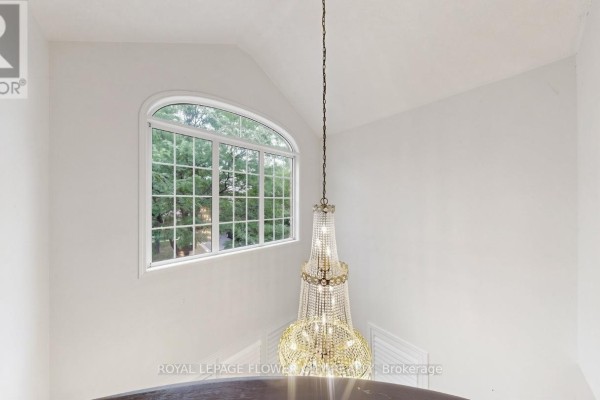 Crystal chandelier and large arched window in hallway - 70 Boom Road Vaughan