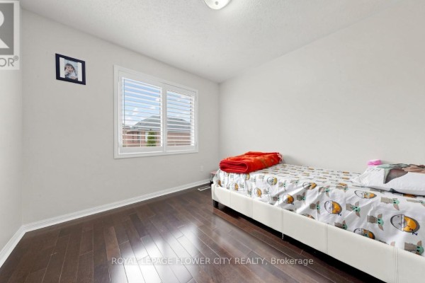 Bedroom with twin bed, themed bedding, and orange throw - 70 Boom Road Vaughan
