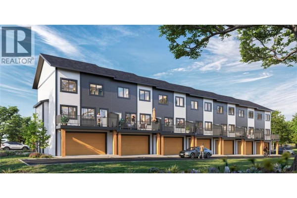 Side view of townhouse with balconies, garages, and green space in front. - 70 Boundary Street Unit# 200, Kimberley
