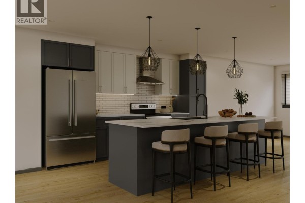 Contemporary kitchen featuring dark cabinetry, stainless steel appliances, and pendant lighting over an island. - 70 Boundary Street Unit# 200, Kimberley