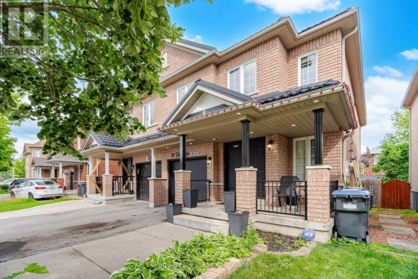 Front exterior of brick townhouses with covered porches and two garages visible. - 70 Echoridge Drive, Brampton
