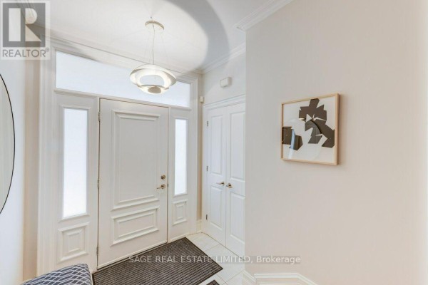 Bright white entryway with double doors, modern light fixture, and artwork. - 70 Heath Street E, Toronto