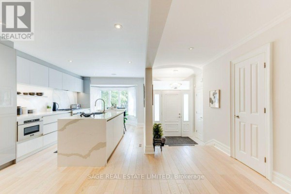 Open concept living area showing kitchen, entryway, and hallway. - 70 Heath Street E, Toronto