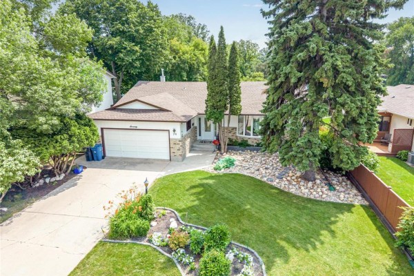 Aerial view of a residential house with a well-maintained lawn and mature trees. - 70 Radcliffe Road, Winnipeg
