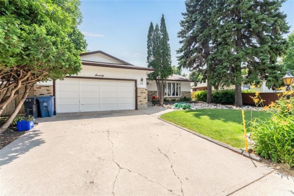Close-up of the driveway and front entrance of a residential property. - 70 Radcliffe Road, Winnipeg
