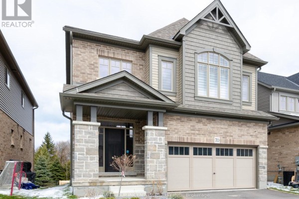 Front view of a two-story detached house with brick and wood siding, a covered porch, and a double garage. - 70 Shipley Avenue, Collingwood