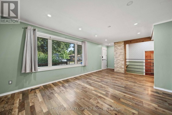 View of the front yard with grass and porch details. - 70 Talavera Crescent, London East