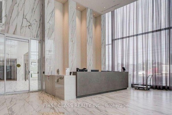 Building lobby features a grey reception desk, marble floors, and floor-to-ceiling windows. - 7005 - 448 Burnhamthorpe Road, Mississauga