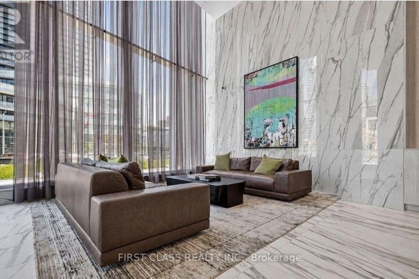 Interior lounge with two brown leather sofas, a coffee table, and modern art on a marble wall. - 7005 - 448 Burnhamthorpe Road, Mississauga