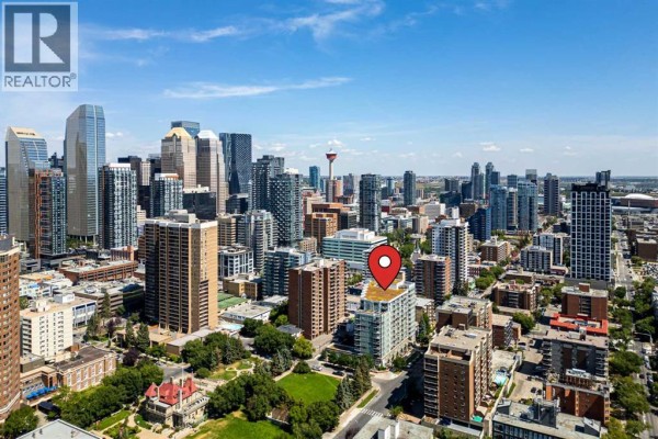 Aerial view of a city skyline with a cluster of skyscrapers and a tower. - 701, 626 14 Avenue Sw, Calgary