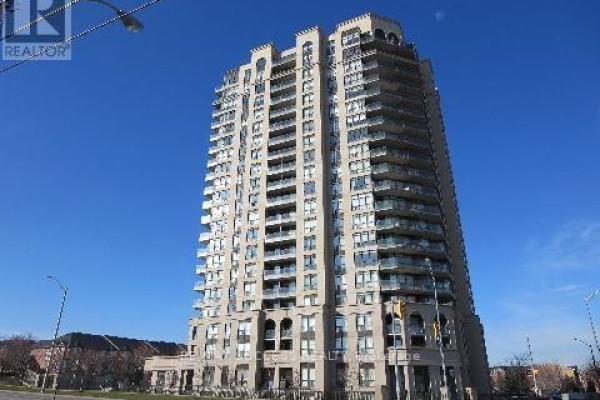 Exterior view of a tall, modern apartment building with many balconies against a clear blue sky. - 701 - 220 Forum Drive, Mississauga