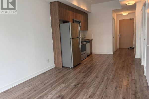 Interior view of a condo showing the living space, kitchen area, and hallway. - 701 - 621 Sheppard Avenue E, Toronto
