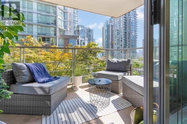 Apartment balcony furnished with grey outdoor seating and a wire metal side table. - 701 565 Smithe Street, Vancouver