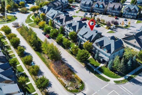 Aerial view of a residential street with townhouses and parked cars. - 702, 50 Belgian Lane, Cochrane