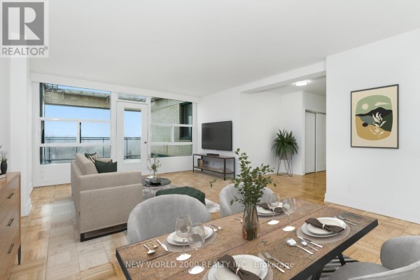Bedroom with large window, wooden floor, television on stand, and mirrored closet doors. - 702 - 40 Park Road, Toronto