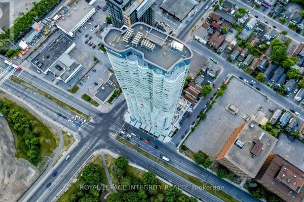 Top-down aerial view of a curved apartment building at a busy intersection. - 703 - 805 Carling Avenue, Ottawa