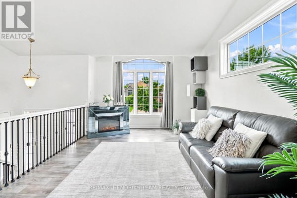 Spacious landing area with natural light, sofa, and decorative accents. - 7032 Kelly Drive, Niagara Falls