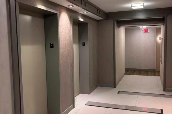 Elevator lobby with grey doors labeled with the number 7. - 704 - 56 Annie Craig Drive, Toronto