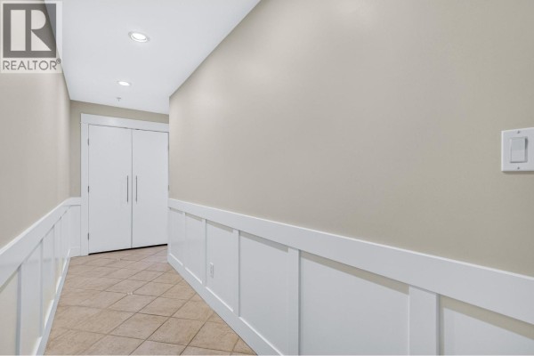 Hallway with tiled floor, cream walls, and white trim. - 704 415 E Columbia Street, New Westminster