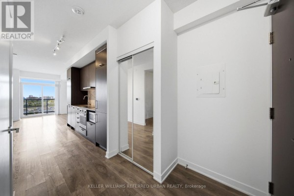 Apartment interior showing hallway, kitchen area with stainless steel appliances, and balcony view. - 706 - 38 Honeycrisp Crescent, Vaughan
