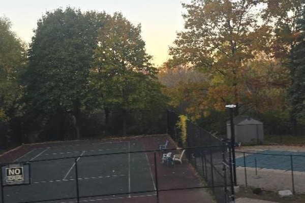 Outdoor tennis court surrounded by trees and a small gazebo - 706 - 600 Rexdale Boulevard, Toronto