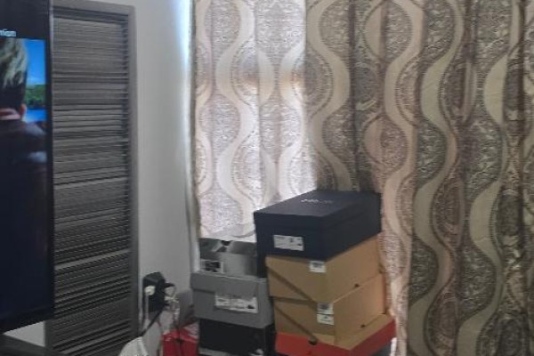 Living area with a television, storage boxes, and patterned curtains - 706 - 600 Rexdale Boulevard, Toronto