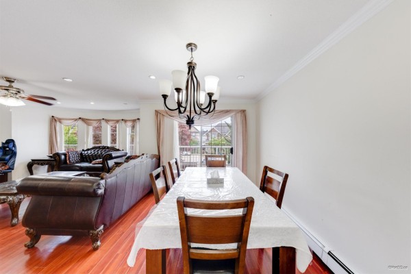 View from the upper floor landing overlooking the living room and dining area. - 7069 144 Street, Surrey