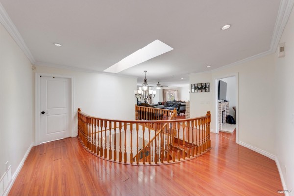 Living room with plush sofas, a round coffee table, and patio doors. - 7069 144 Street, Surrey