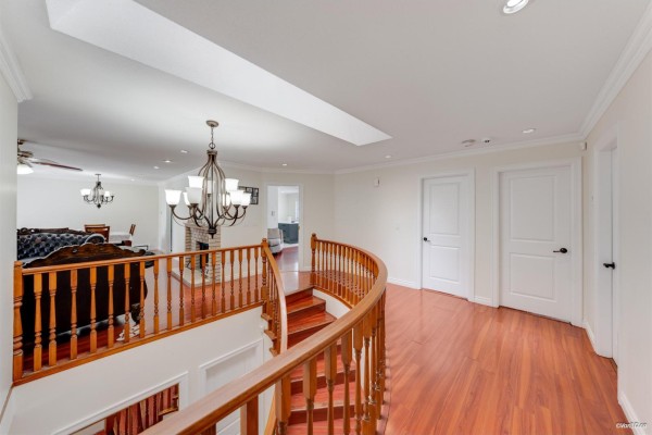 Modern kitchen with white and grey cabinetry, a large island, and stainless steel appliances. - 7069 144 Street, Surrey