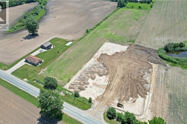 Aerial view of cleared land on a rural property with excavation work and construction equipment visible. - 707016 Township Road 2 Road, Princeton