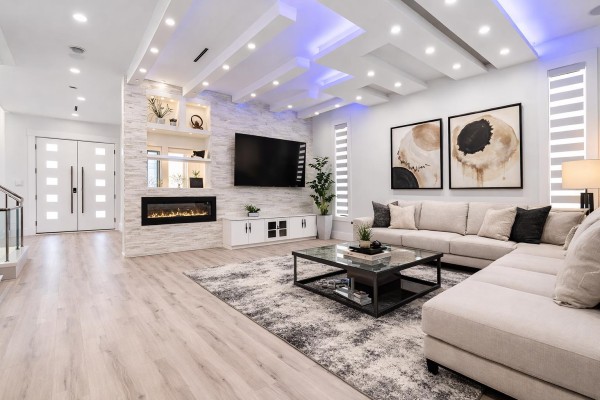Stylish lounge with recessed lighting, artwork, and modern furniture - 7079 194a Street, Surrey