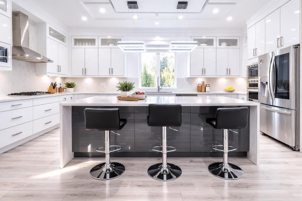 Gourmet kitchen with white cabinets, large island, and stainless steel appliances - 7079 194a Street, Surrey