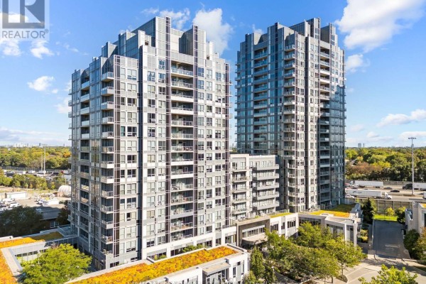 Exterior aerial view of two modern high-rise apartment buildings with balconies, surrounded by trees and a highway. - 708 - 120 Harrison Garden Boulevard, Toronto