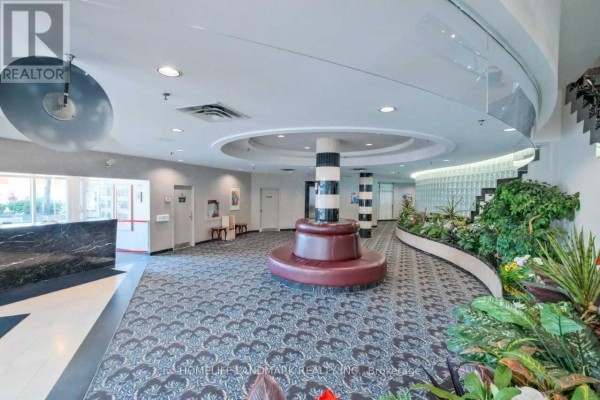 Building lobby with tile floor, recessed lighting, and elevator access doors. - 708 - 1470 Midland Avenue, Toronto
