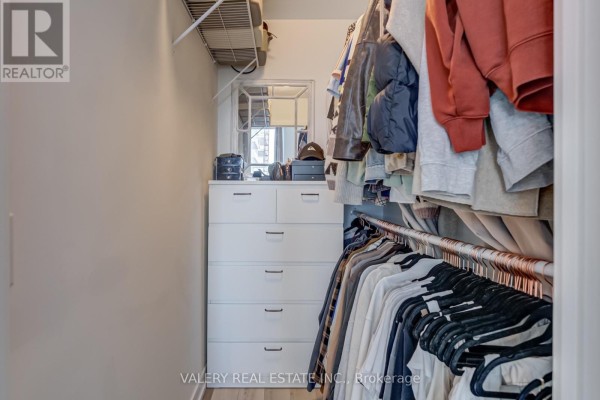 Walk-in closet with built-in drawers, shelving, and ample hanging space for clothes. - 708 - 1480 Bayly Street, Pickering