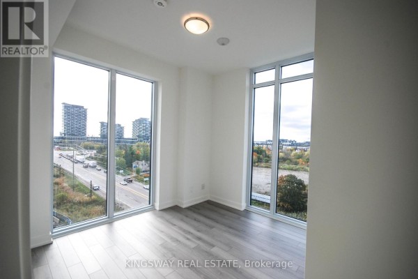 Corner room with two large windows showing city views, traffic, and trees. - 708 - 3071 Trafalgar Road, Oakville