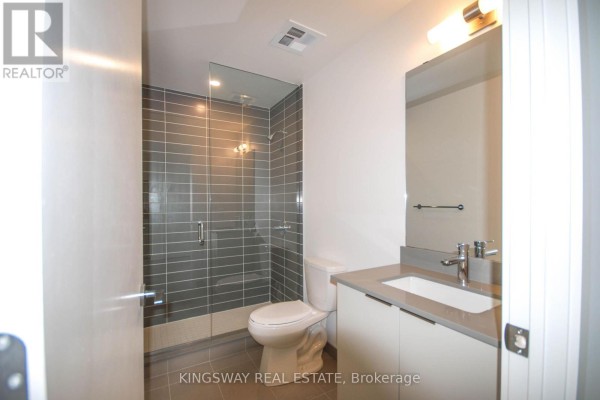 Bathroom with a modern vanity, sink, toilet, and a grey tiled walk-in shower. - 708 - 3071 Trafalgar Road, Oakville