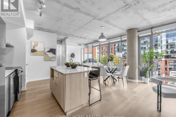 View of the open concept living, dining, and kitchen area with city views. - 708 - 650 King Street West Street W, Toronto