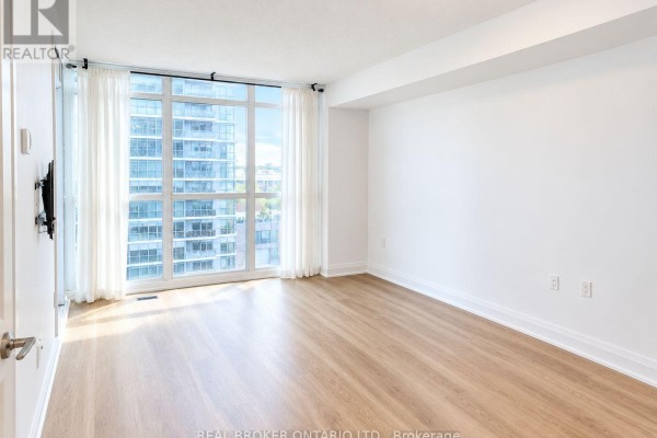 Bedroom with large windows, sheer white curtains, light wood flooring, and a distant city view. - 708 - 9 Valhalla Inn Road, Toronto