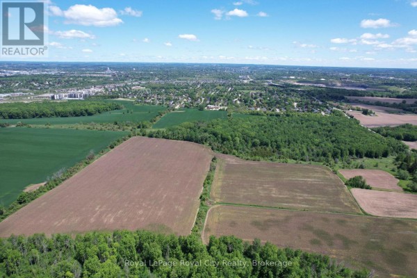 Wide aerial perspective of rural landscape with fields, trees, and residential buildings. - 7096 Fife Road, Guelph/eramosa
