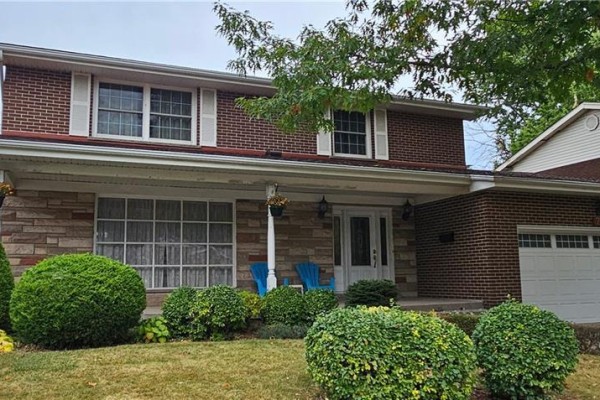 Exterior view of a two-story house with red brick siding, white shutters, and an attached garage. - 71 Margate Avenue, Hamilton
