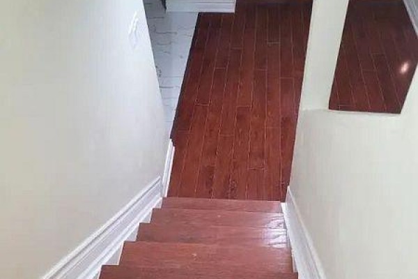 View looking down a staircase with wood flooring and white banisters and trim. - 71 Middlecote Drive, Ajax