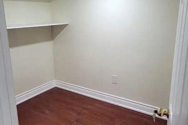 Small empty room with wood flooring, cream walls, and a single white shelf. - 71 Middlecote Drive, Ajax